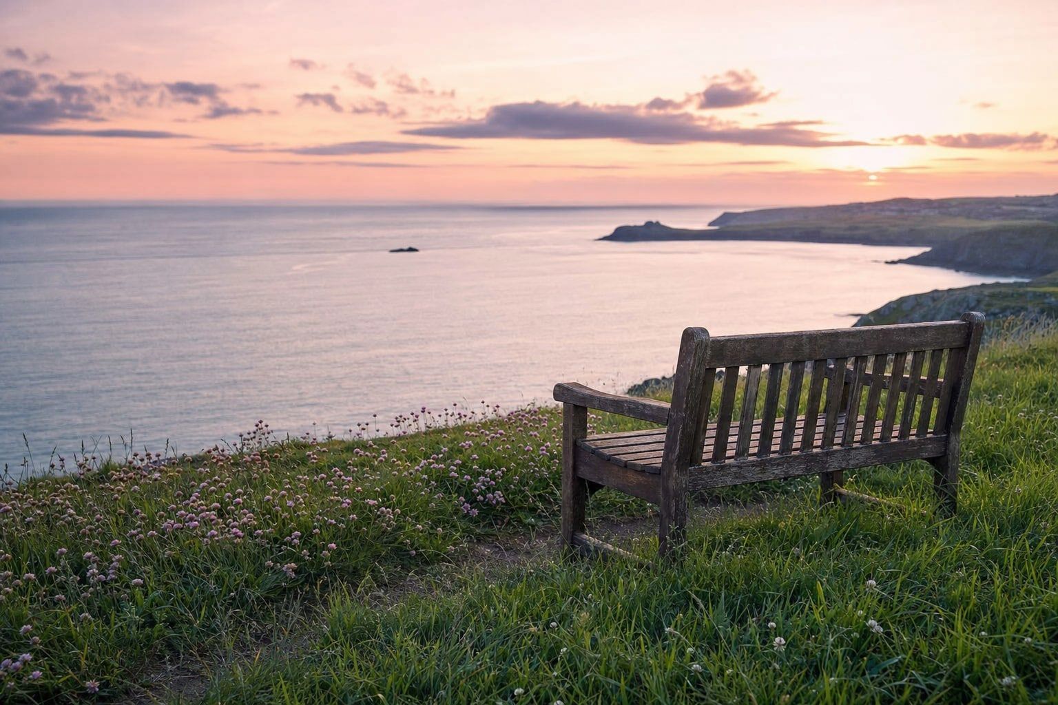 An empty bench overlooking the sea at dawn