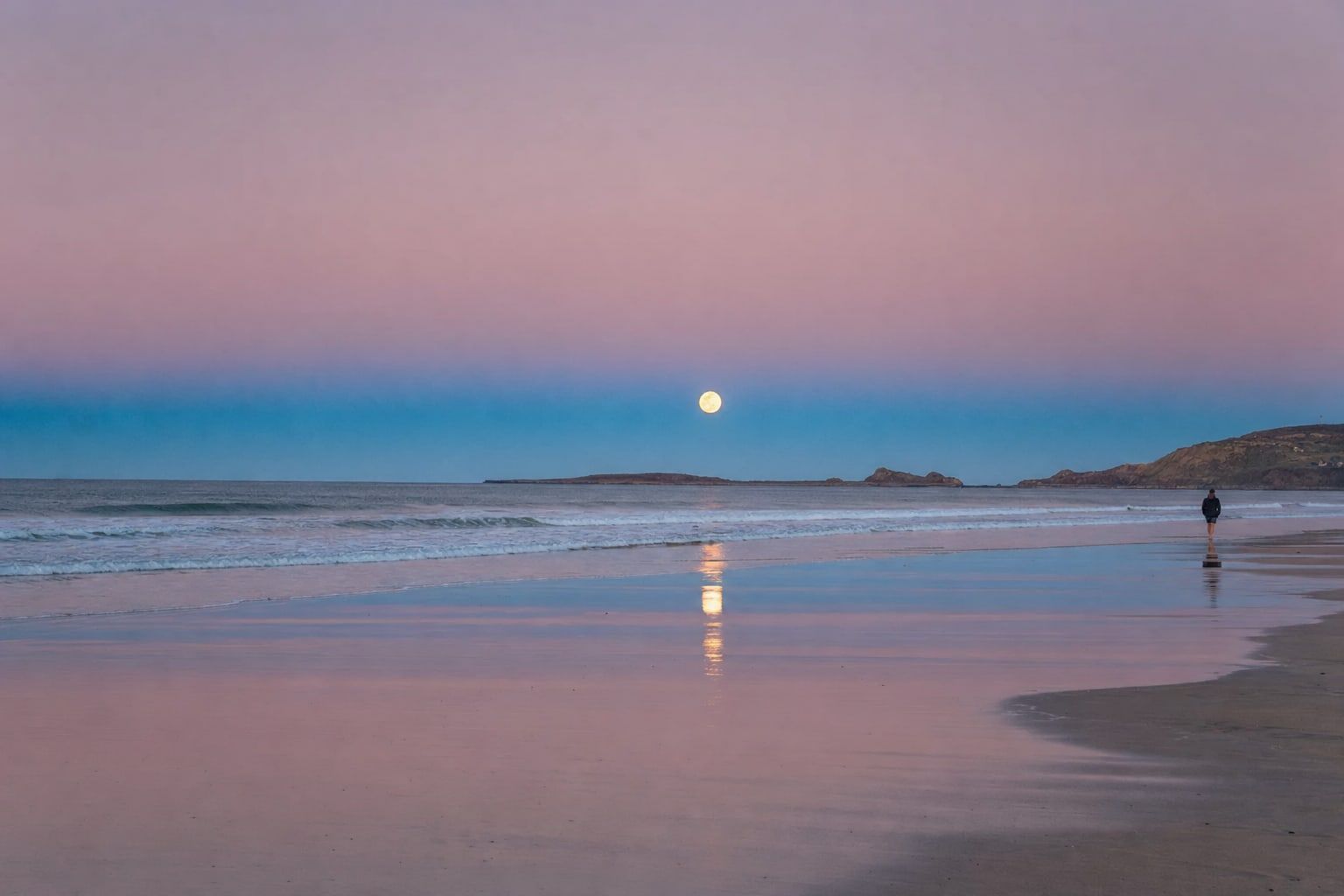 Full moon rising over the sea at dusk with the Earth's shadow