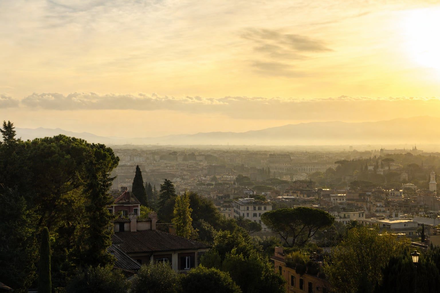 Sunrise over Rome and the Colosseum Golden sunrise over Rome with the Colosseum distant in the morning haze