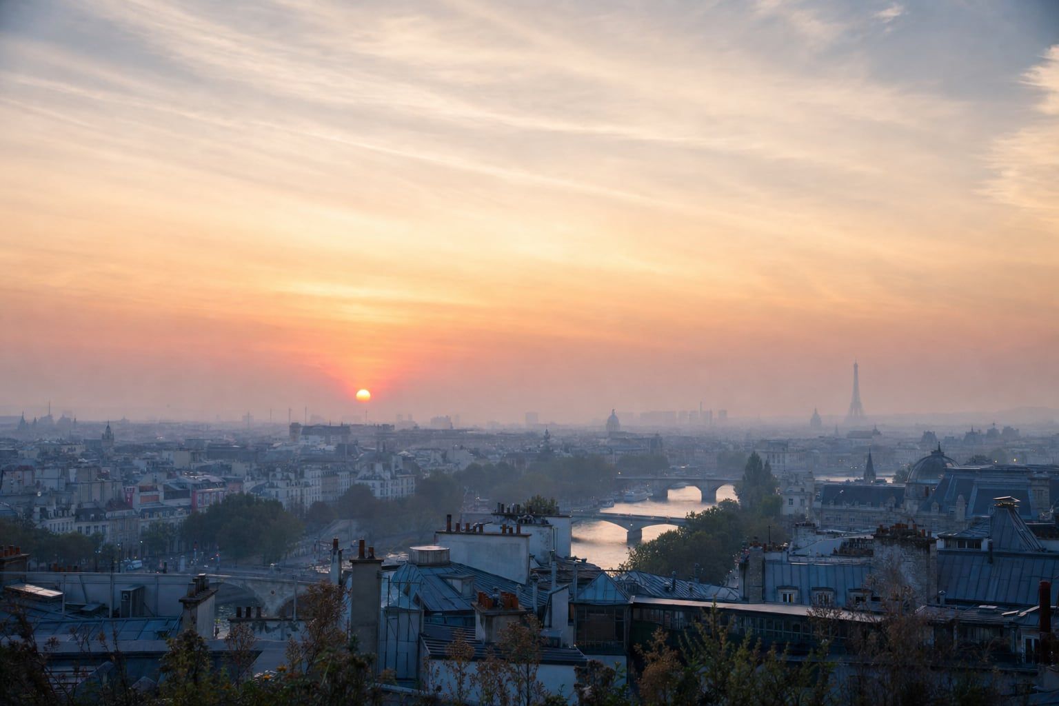 Sunrise over Paris and the Eiffel Tower Sunrise mist over the Paris rooftops with the Eiffel Tower as a distant silhouette