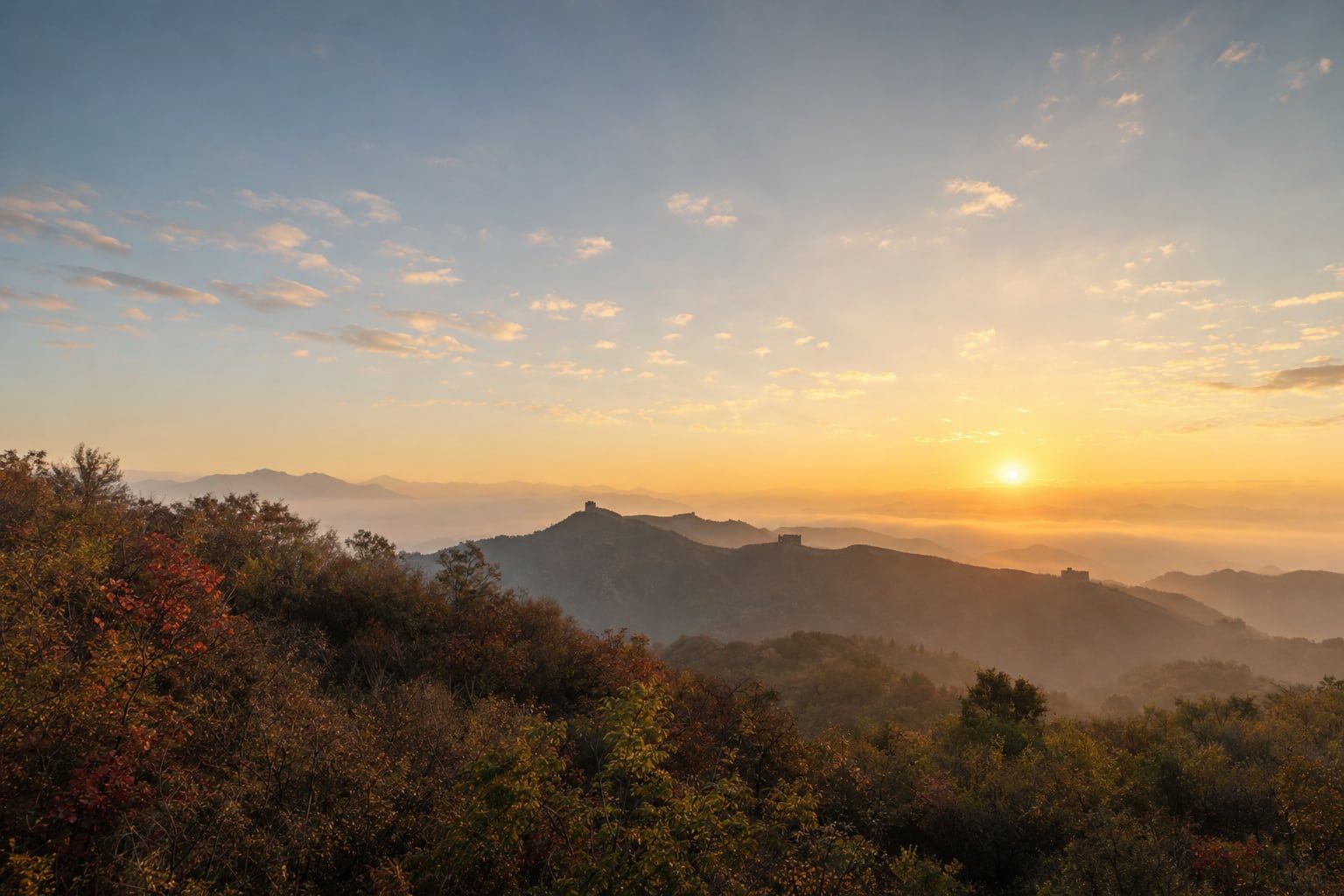Sunrise over the Great Wall at Mutianyu Sunrise over misty mountain ridges with the Great Wall winding into the distance