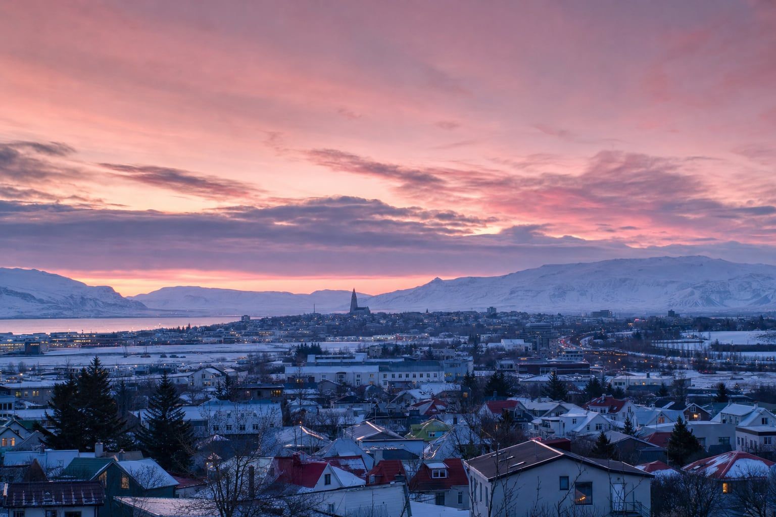 Sunrise over Reykjavík and Hallgrímskirkja Pink winter dawn over Reykjavík with Hallgrímskirkja in the distance