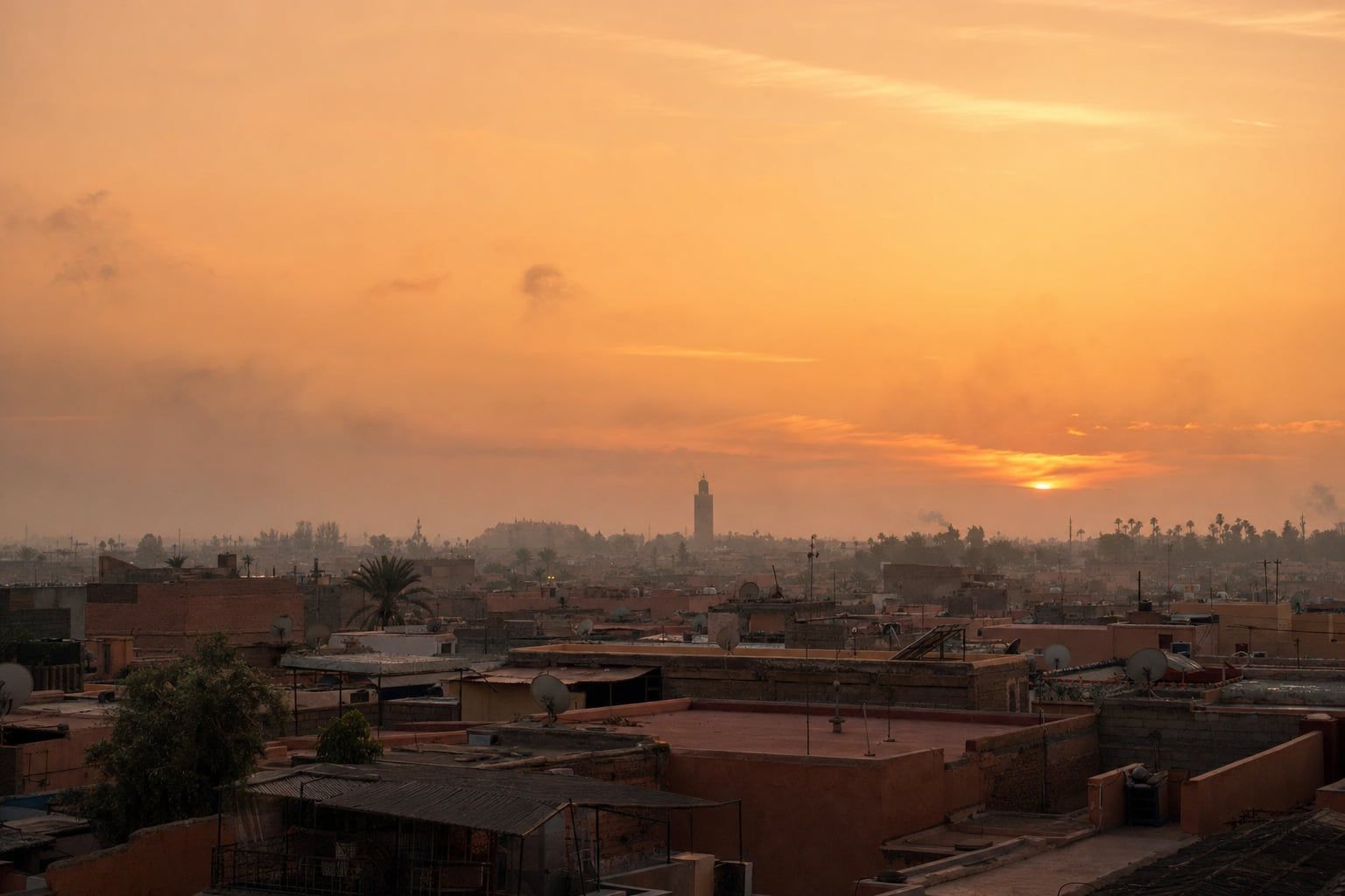 Sunset over Marrakesh Orange sunset over the rooftops of Marrakesh with a distant minaret