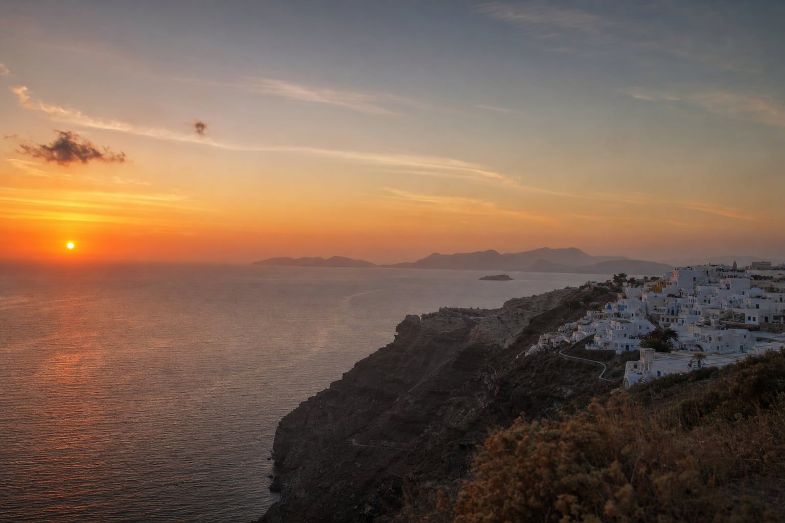 Sunset at Oia, Santorini Sunset over the Aegean Sea from the cliffs of Oia, Santorini
