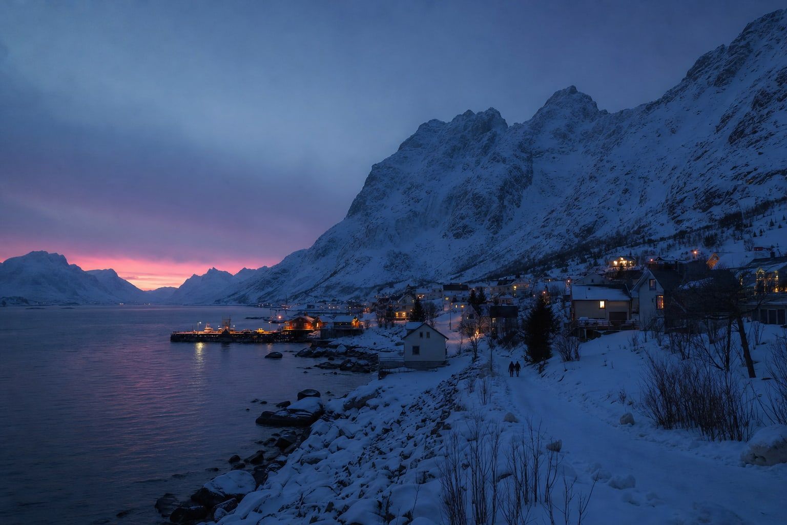 Midday blue twilight over a snowy Arctic fjord town during polar night