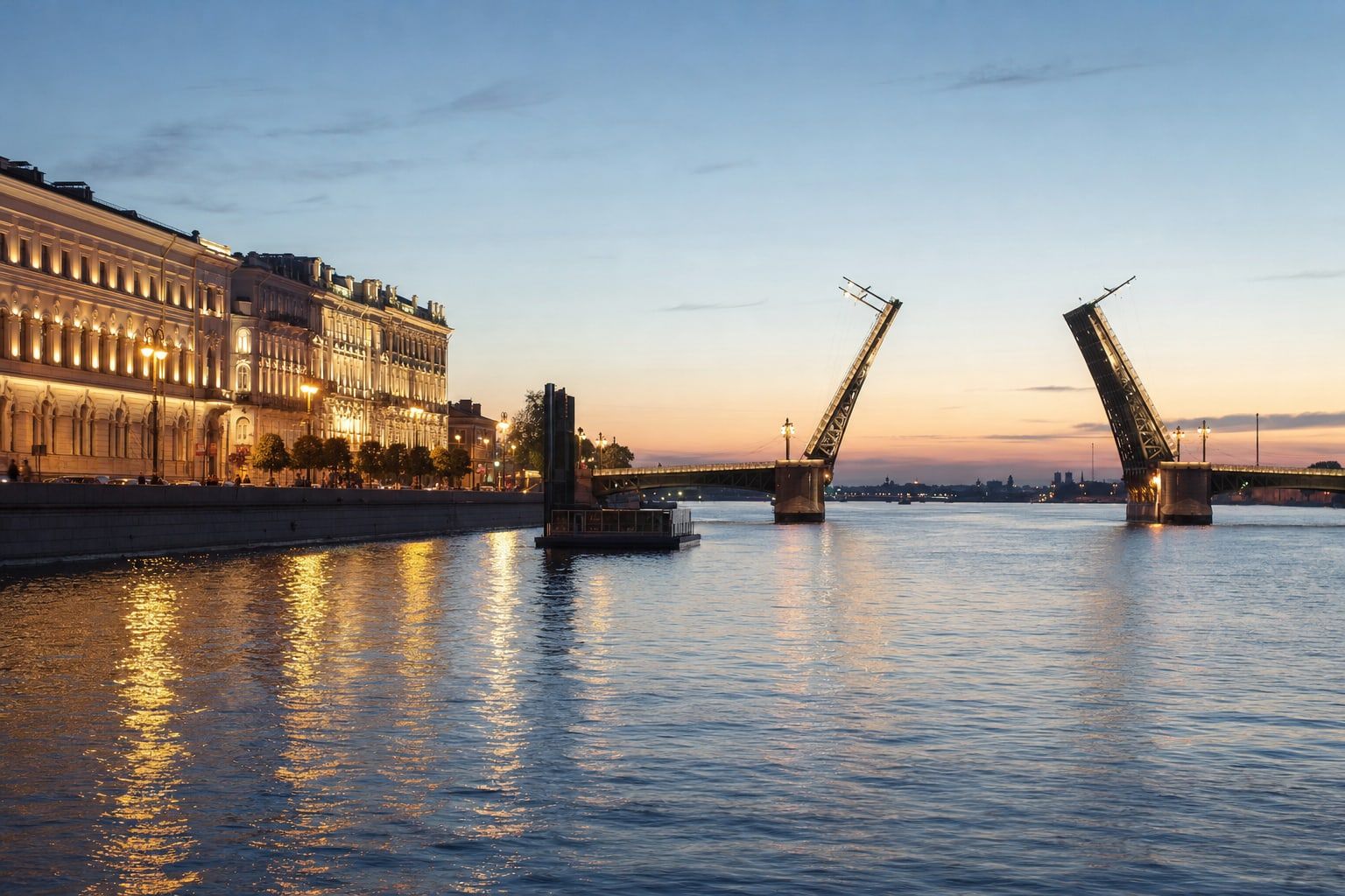 Classical riverside buildings and an open bridge under a pale midnight sky