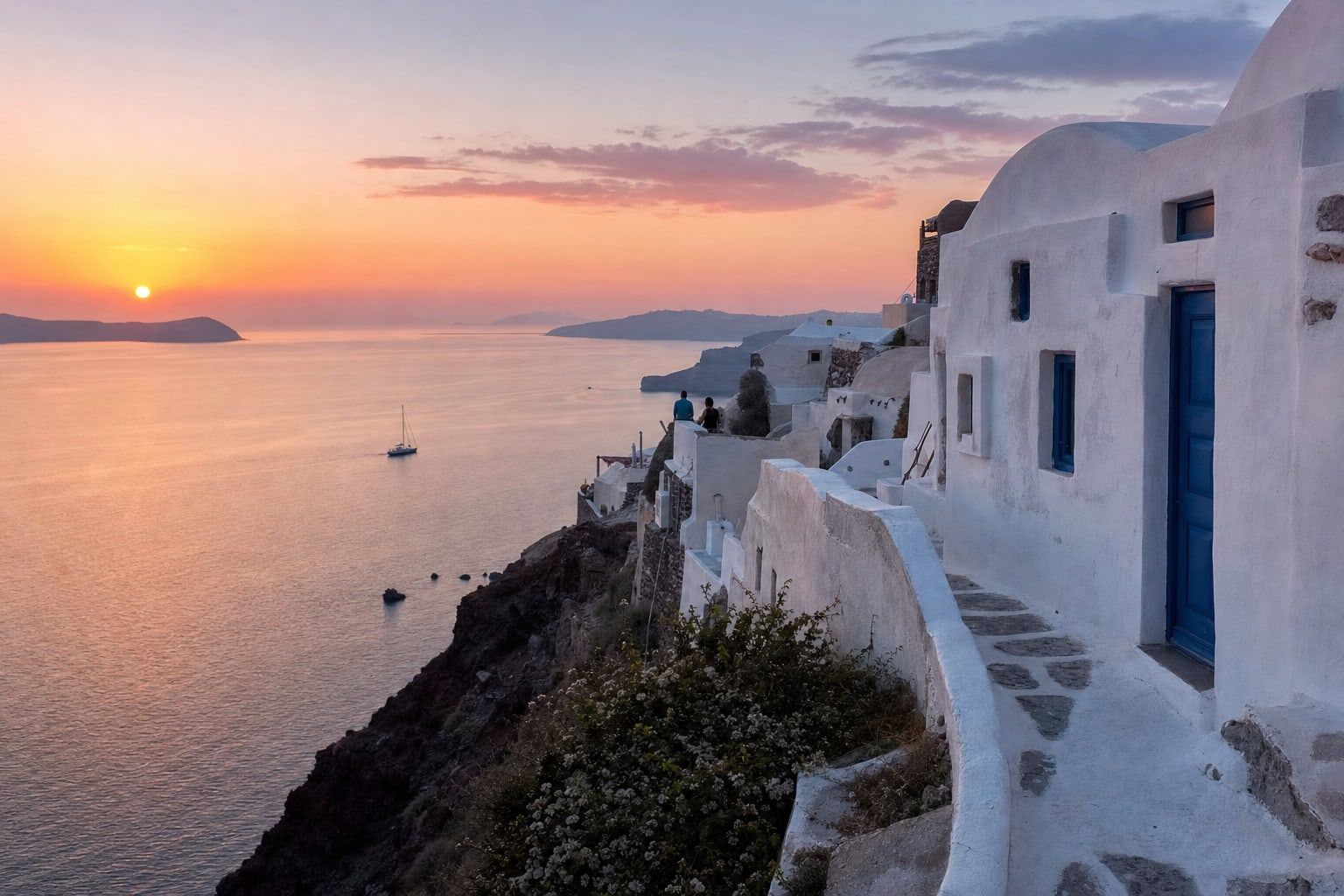 Whitewashed cliff village above the Aegean at sunset